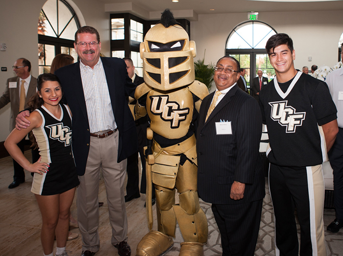 Pat Clark (left), WESH 2 sports anchor, and Belvin Perry, personal-injury attorney and former chief judge in Florida's Ninth Judicial Circuit, joined Knightro and two of UCF's cheerleaders for the annual MPC UCF Touchdown Breakfast on April 29.
