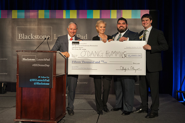 UCF student-entrepreneurs Jesse Wolfe (second from right) and Ryan Atkins (right) won the $15,000, second-place award for their venture, O'Dang Hummus, at the Blackstone Charitable Foundation's Demo Day.