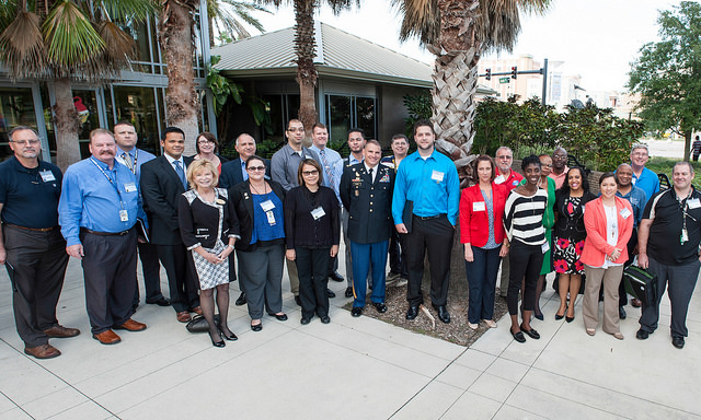 Col. Jeffrey Yarvis (center in uniform) with School of Social Work Director Bonnie Yegidis (left in front row) and veterans who participated in the workshop