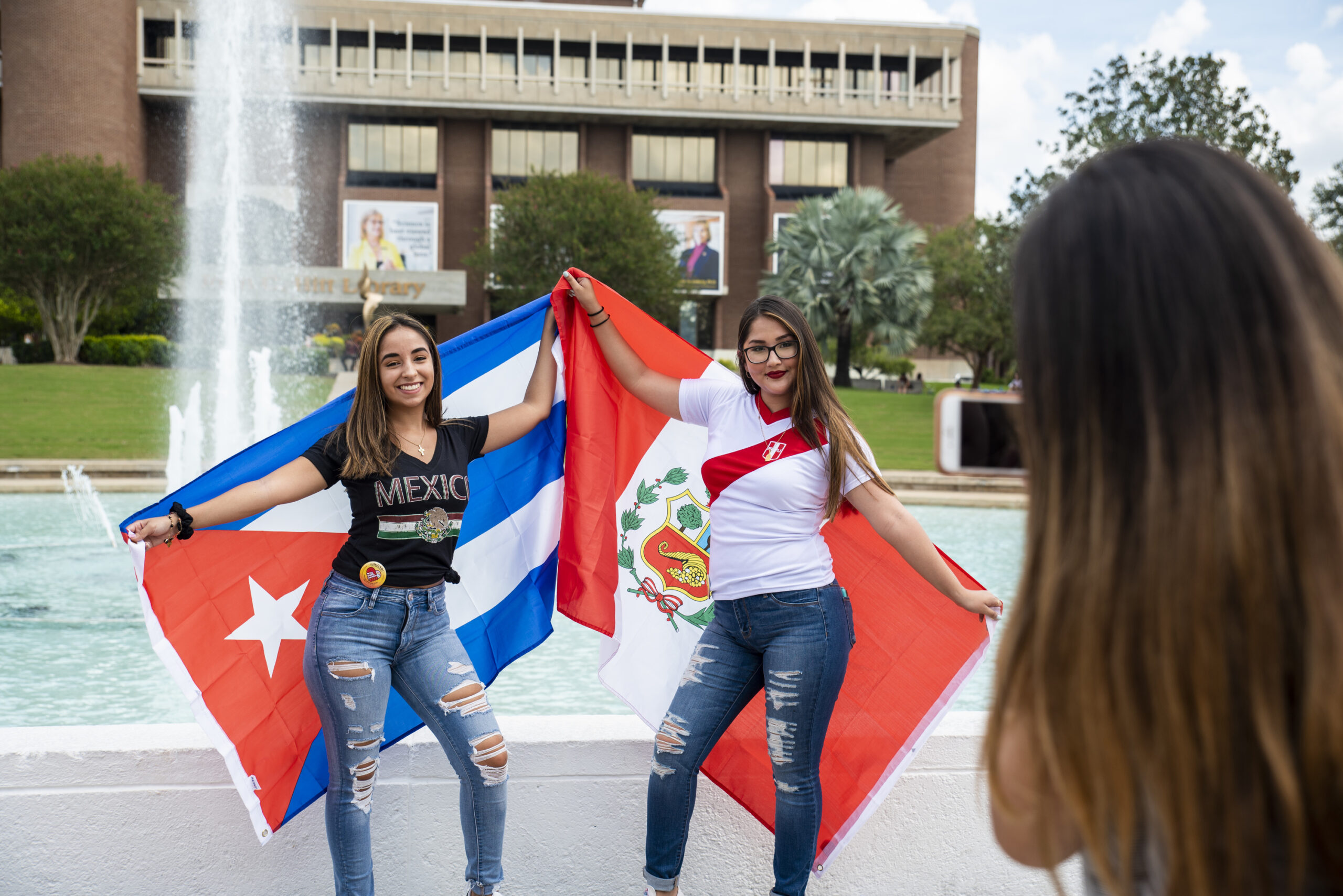 Photo of UCF students with flags in front of Reflecting Pong