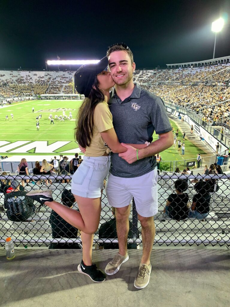 couple posing at football game