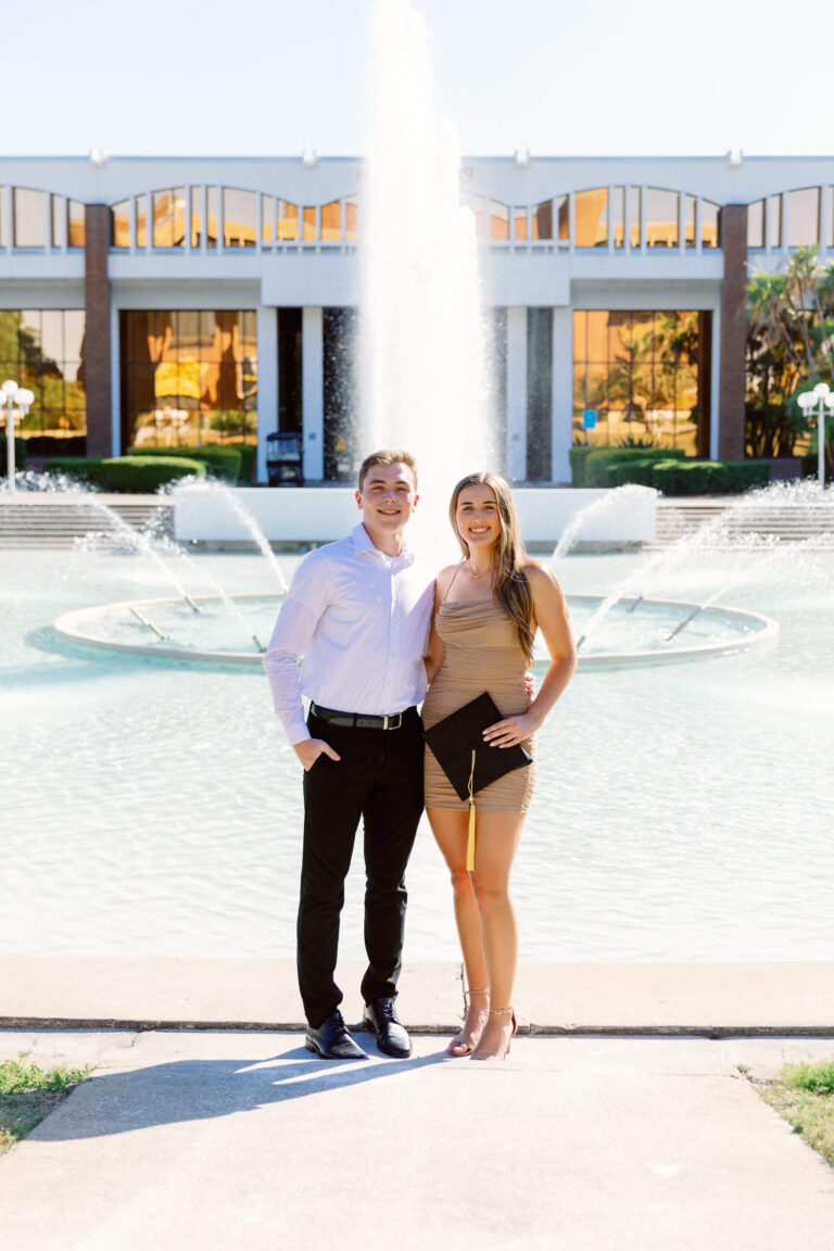 couple standing in front of fountain