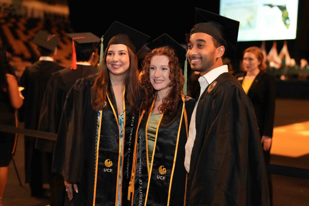 Image of three graduates at Grad Walk