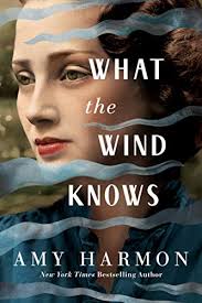 Book cover with a woman's face close-up and the title What the Wind Knows by Amy Harmon,