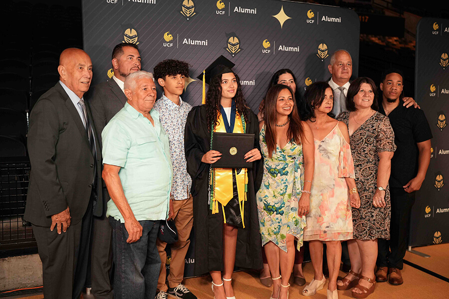 UCF Grad Walk image of graduate with family