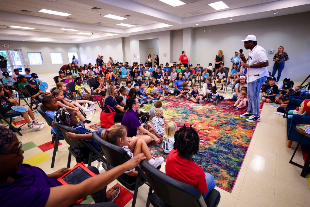 man reading to children at event