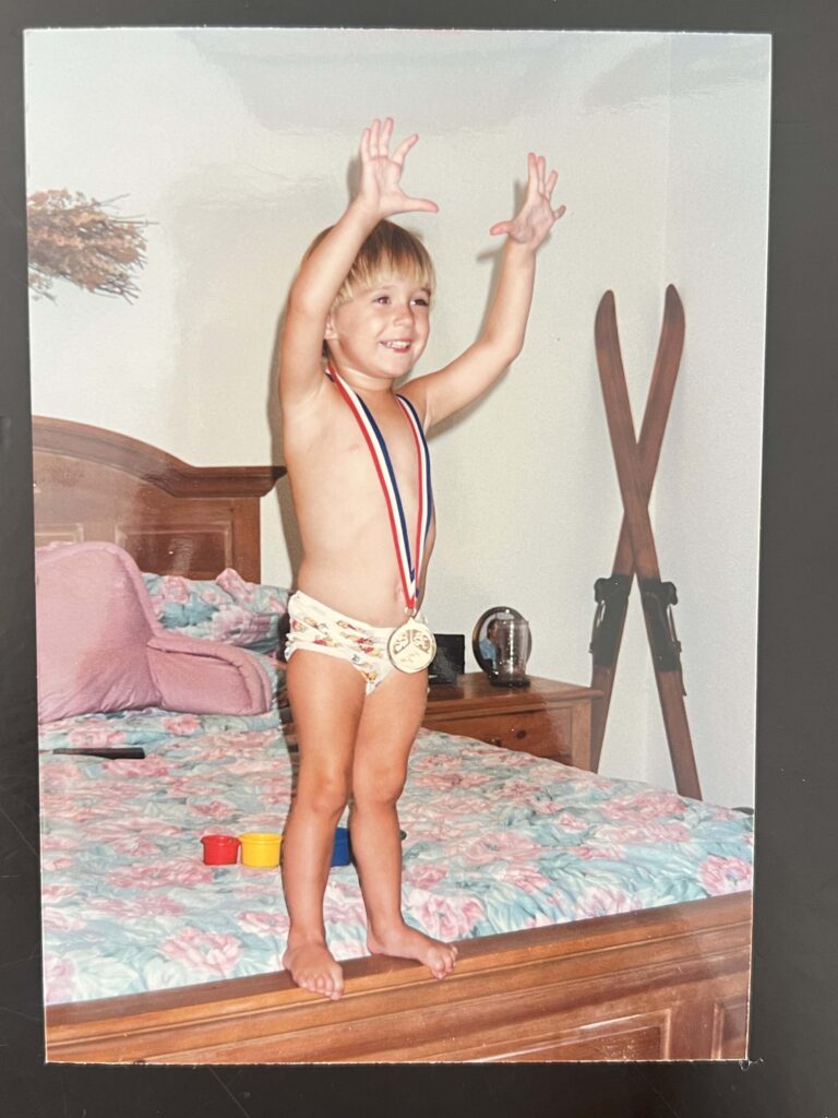 baby posing with medal