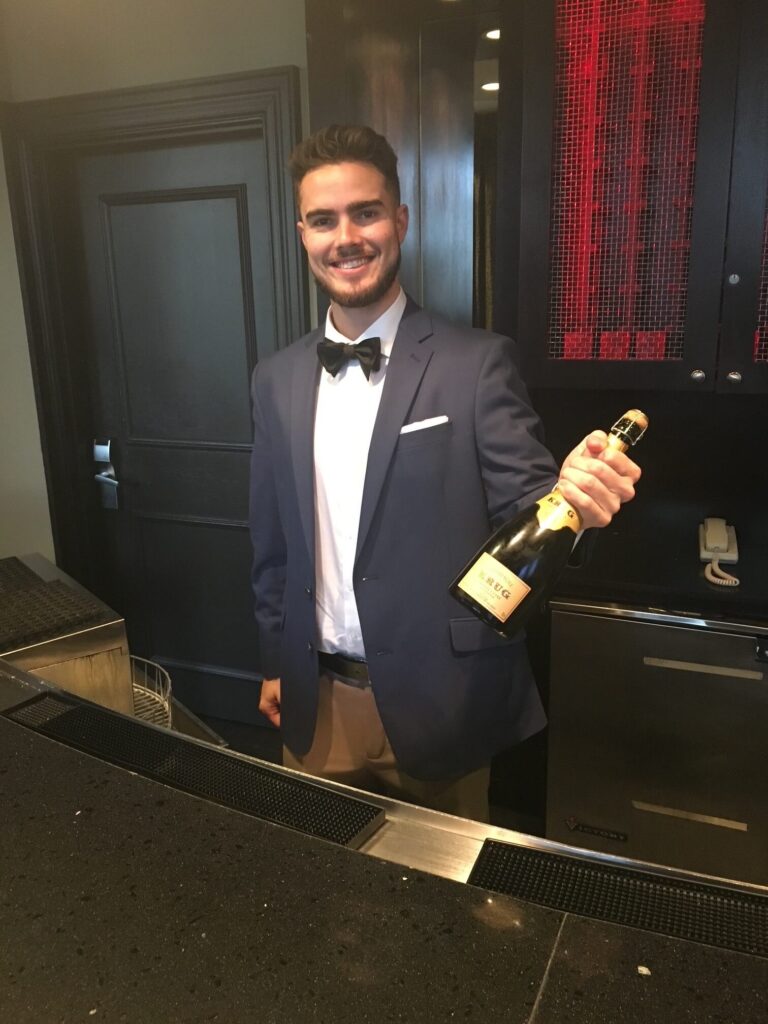 man holding bottle of wine