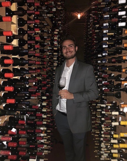 man in room full of wine