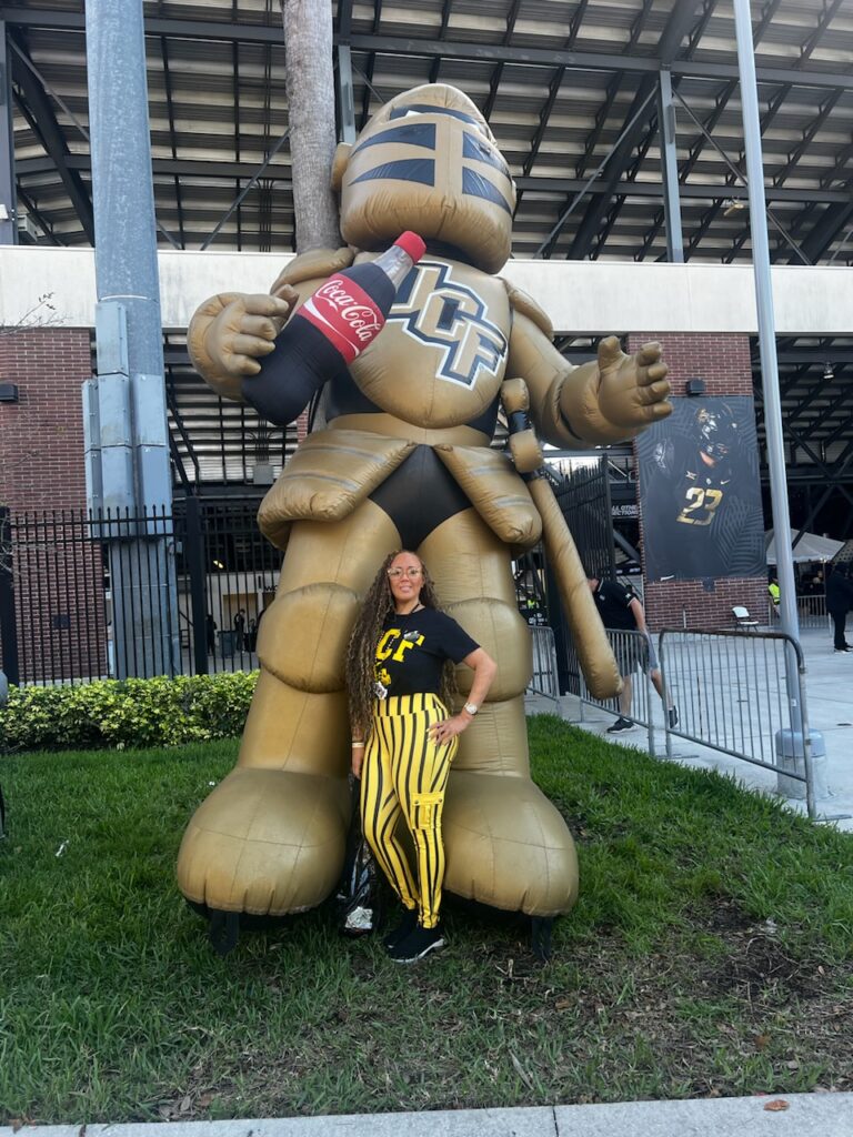 woman with  giant inflateable at stadium
