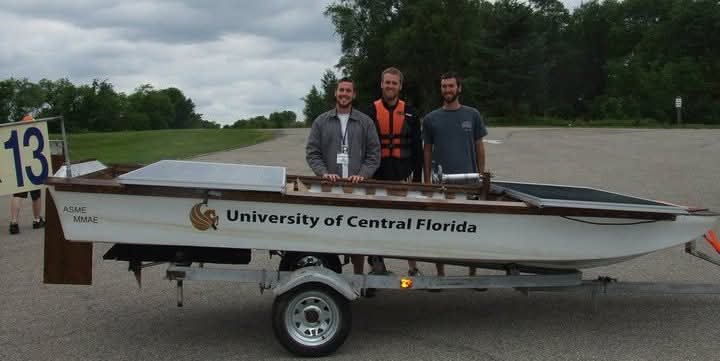 three men with a boat