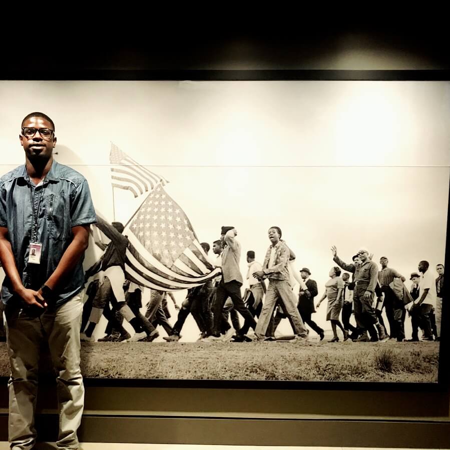 man standing in front of historical photo
