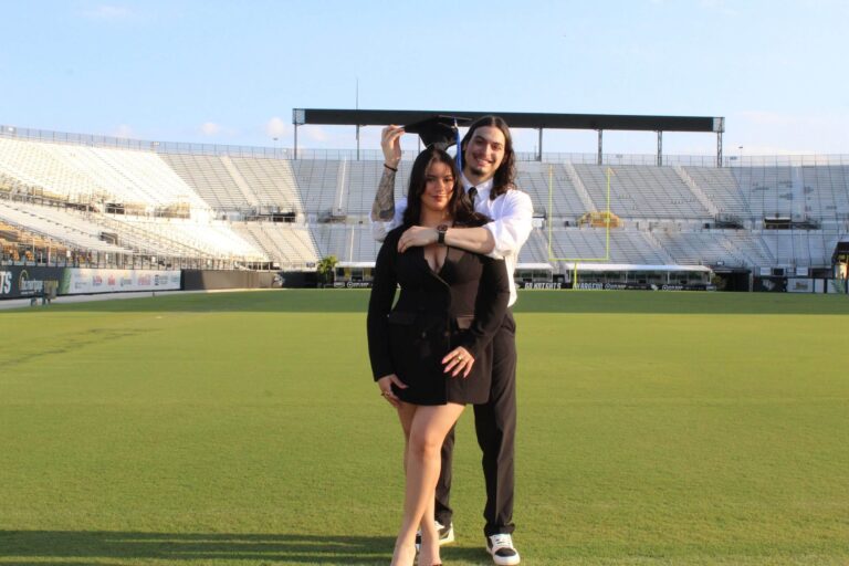 man and woman on football field