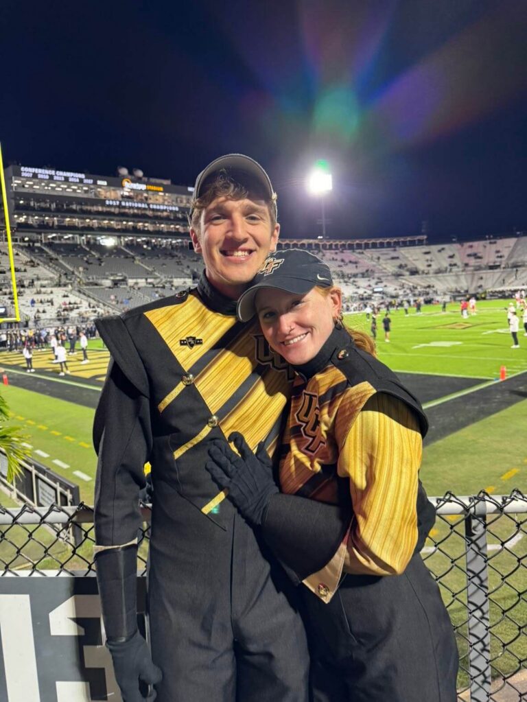 man and woman in band uniforms