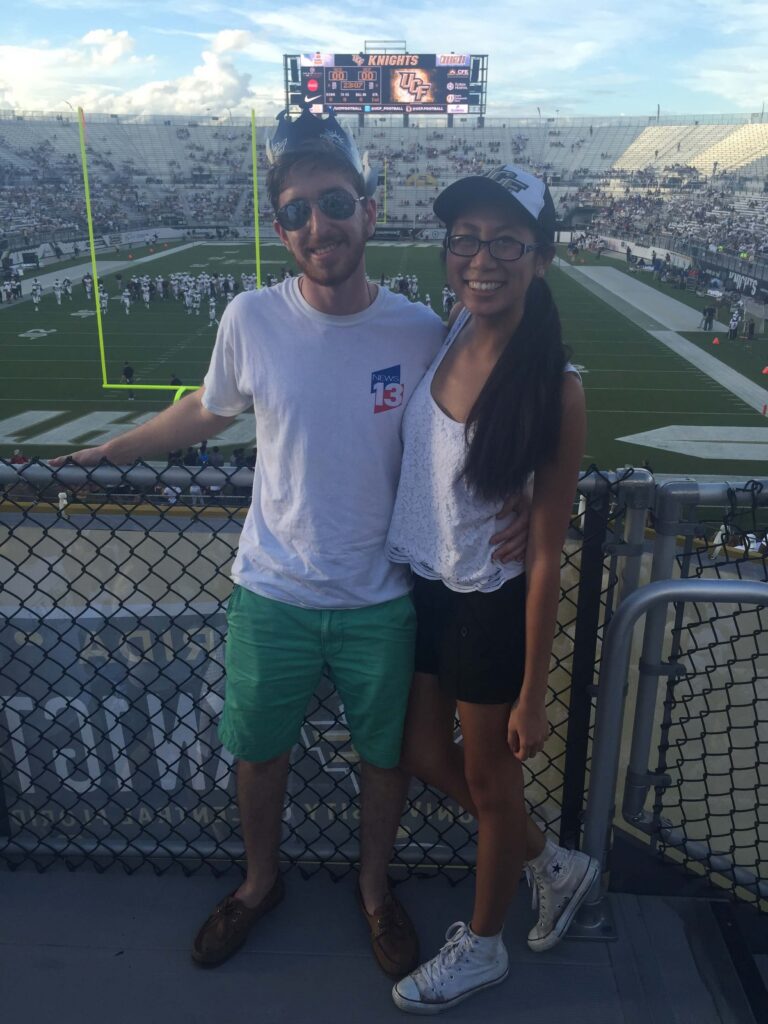 man and woman on football field