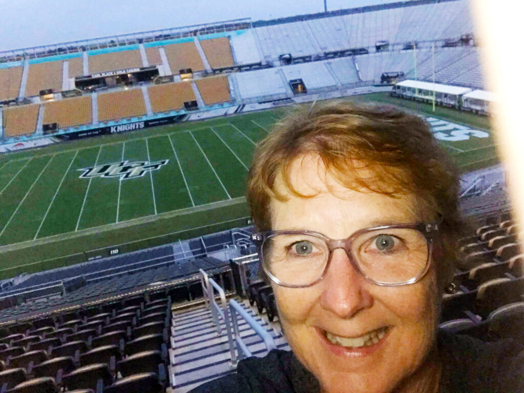 woman at empty football stadium