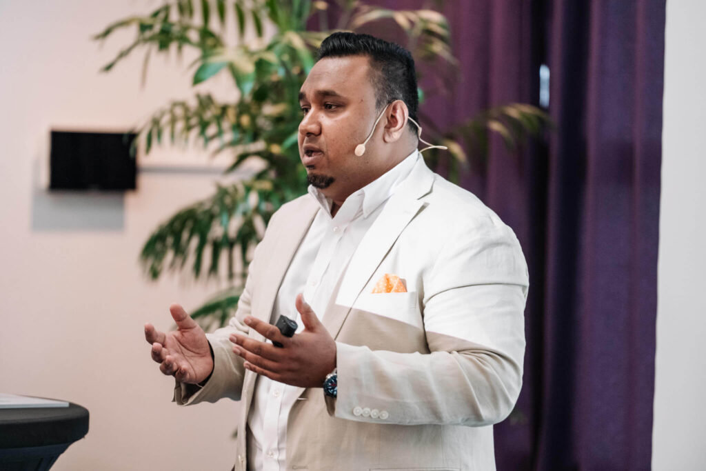 man presenting in front of group