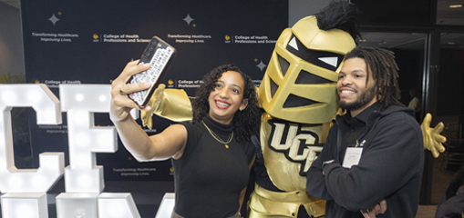 two people taking a selfie photo with Knightro