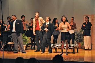 cast on stage singing