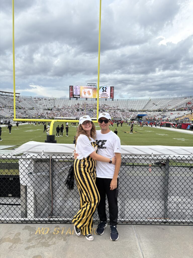man and woman on football field
