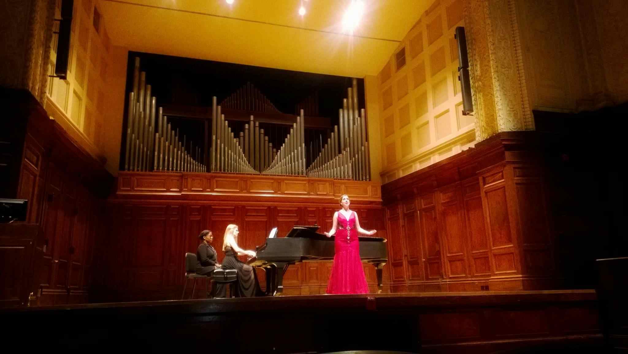 woman singing in grand hallway