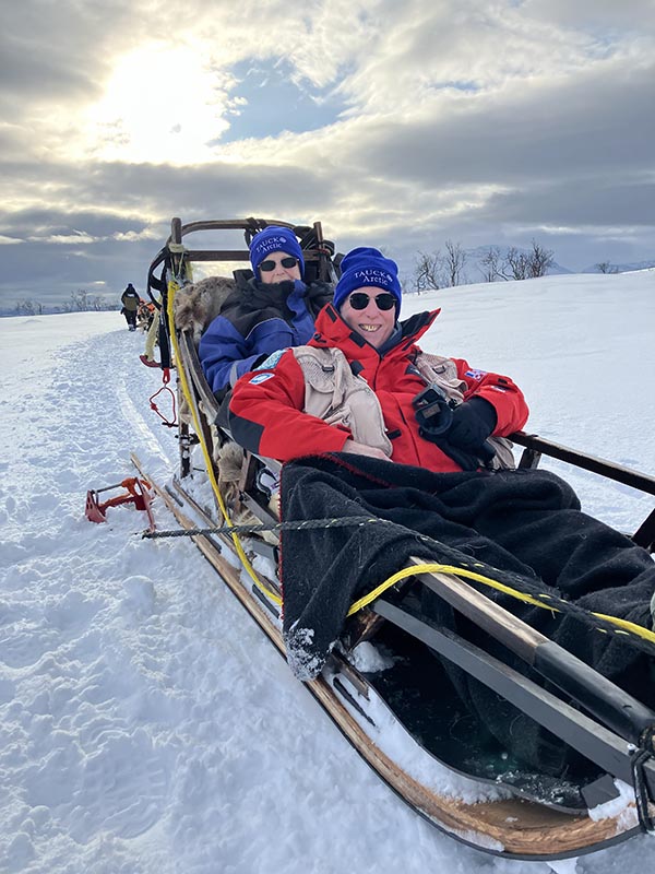 man and woman on dog sled