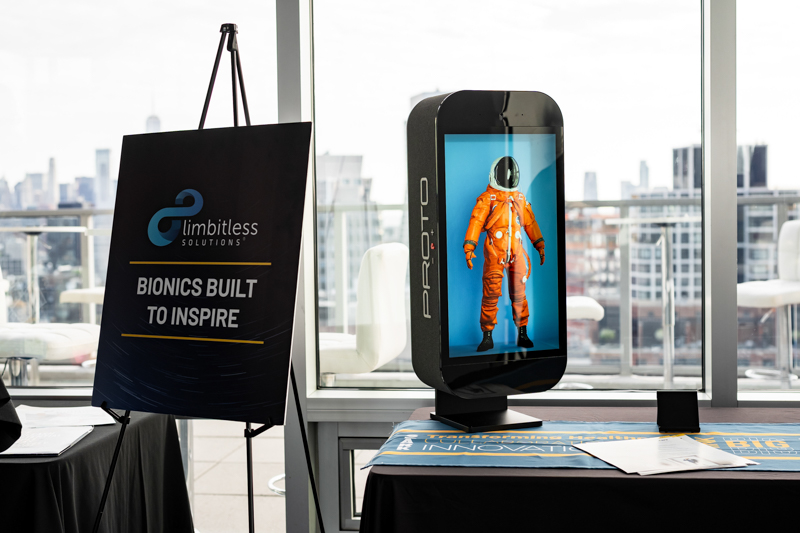 Exhibit showing a bionics display with a life-sized astronaut suit on a screen and a sign that reads 'BIONICS BUILT TO INSPIRE'.