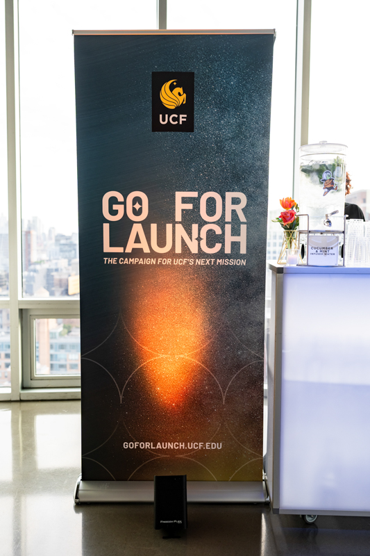 Vertical banner promoting UCF's 'Go for Launch' campaign, featuring the UCF logo at the top and the text 'GO FOR LAUNCH' with 'THE CAMPAIGN FOR UCF'S NEXT MISSION' on a space-themed background.