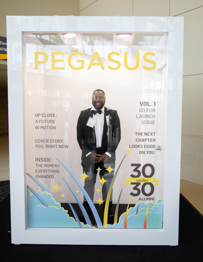 Promotional Pegasus magazine display: a man in a tuxedo on the cover, bold yellow PEGASUS title, with blue wave and star graphics at the bottom.