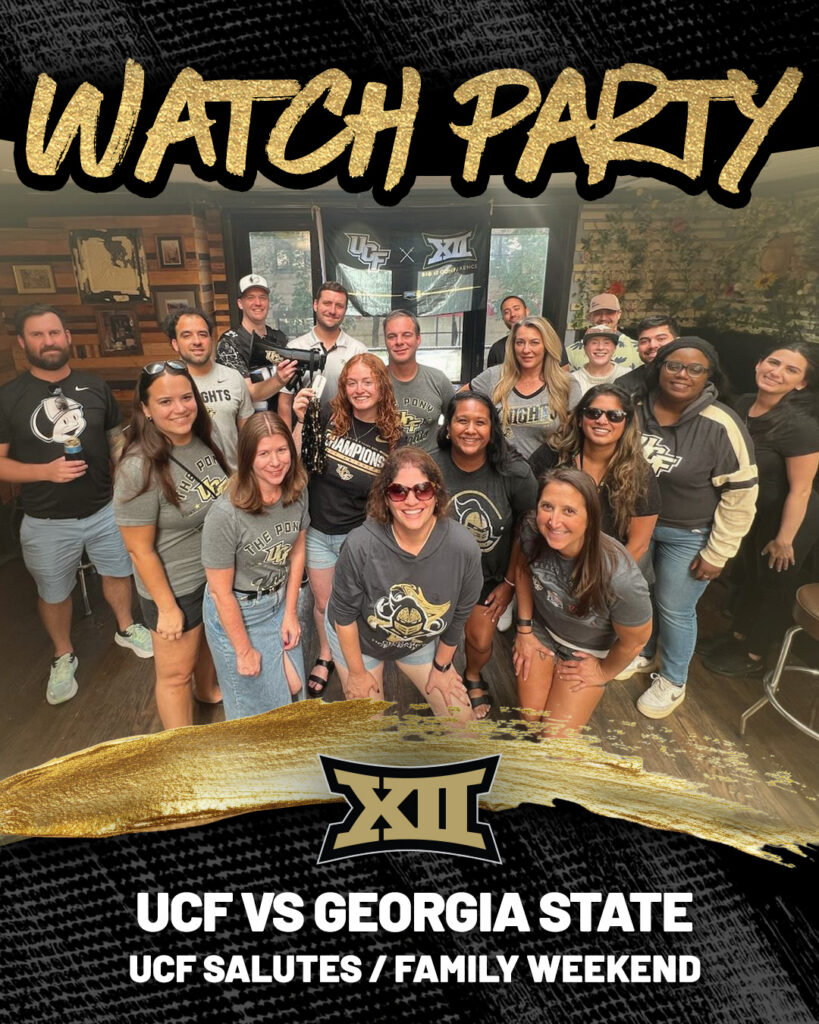Group of diverse fans in UCF shirts posing for a watch party photo indoors, with banners reading UCF vs Georgia State in the background.