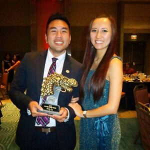 man and woman holding award