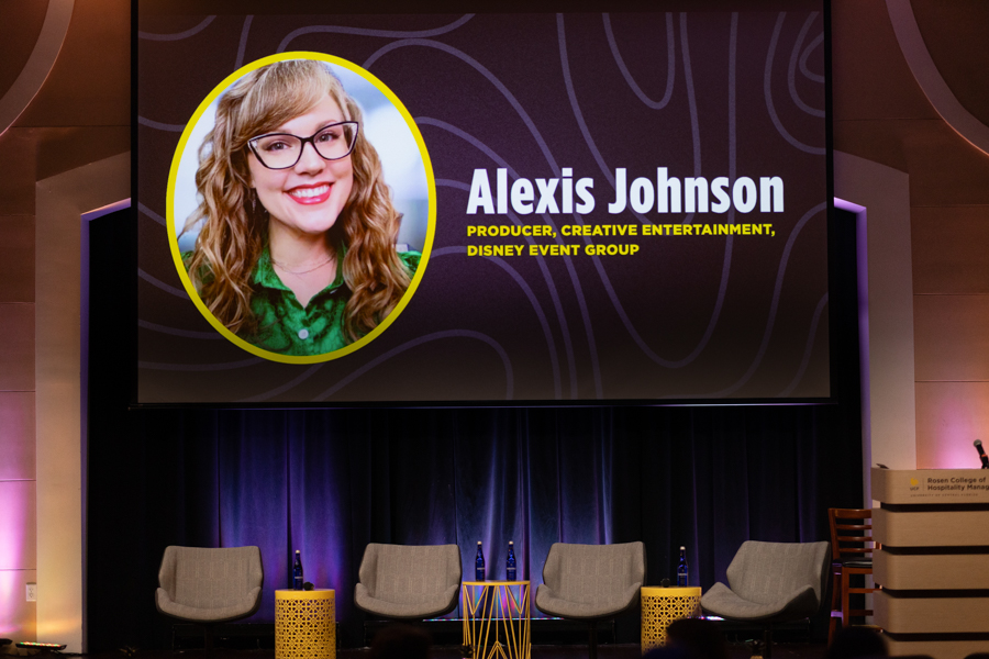 Stage slide featuring Alexis Johnson portrait in a yellow circle; name and title read: Producer, Creative Entertainment, Disney Event Group on a purple backdrop.