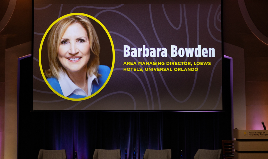 Portrait of Barbara Bowden with her name and title on a conference slide: Area Managing Director, Loews Hotels, Universal Orlando, on a decorative background.