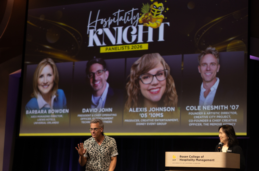 Four panelists stand on a stage in front of a large screen that reads ‘Hospitality Knight Panelists 2026’ with the speakers’ names visible (Barbara Bowden, David John, Alexis Johnson, Cole Nesmith).