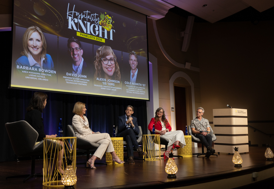 Five panelists sit on a stage in a discussion, with a large screen behind them reading 'Hospitality Knight: Panelists 2026' and showing headshots of four speakers (Bowden, John, Johnson, Nesmith).